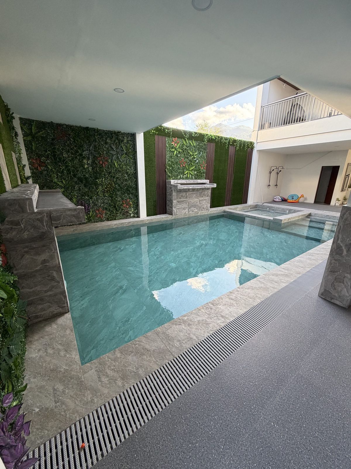 The pool seen from the lounge, with the mezzanine walkway and open sky above it